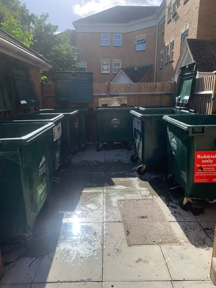 Emptied communal bins with the walkway cleared.